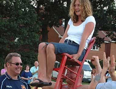 Strongman Holding Lady on a Chair