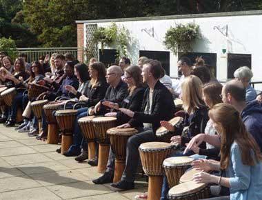 People drumming at a team building event