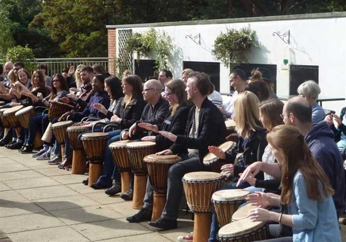 People drumming at a team building event