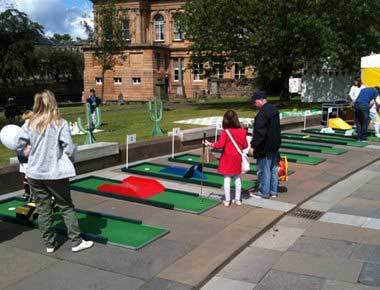 People playing Crazy Golf