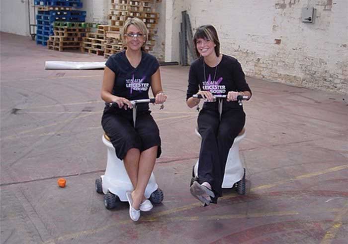 Ladies sitting on racing toilets